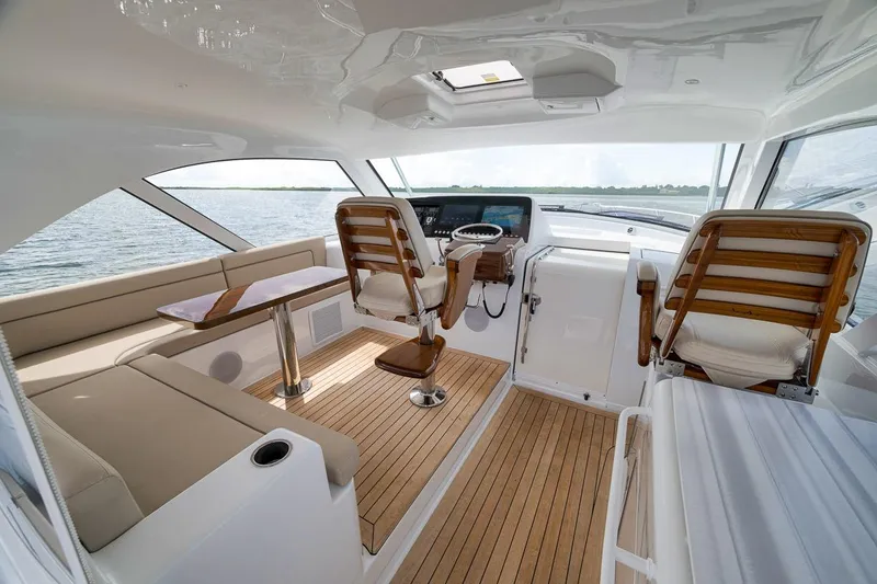 Slide: The Image of Luxurious interior of 2023 Hatteras GT45X Tower yacht with wooden accents and seating. - 24