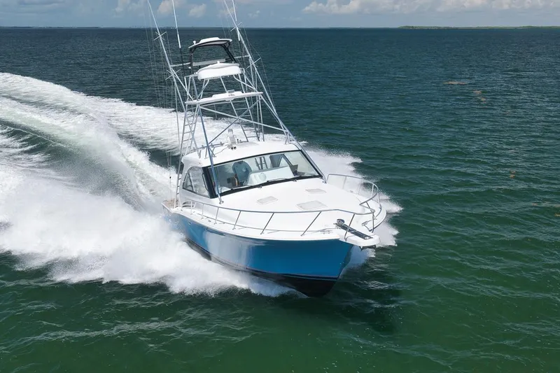 Slide: The Image of 2023 Hatteras GT45X Tower yacht cruising swiftly on open water. - 3