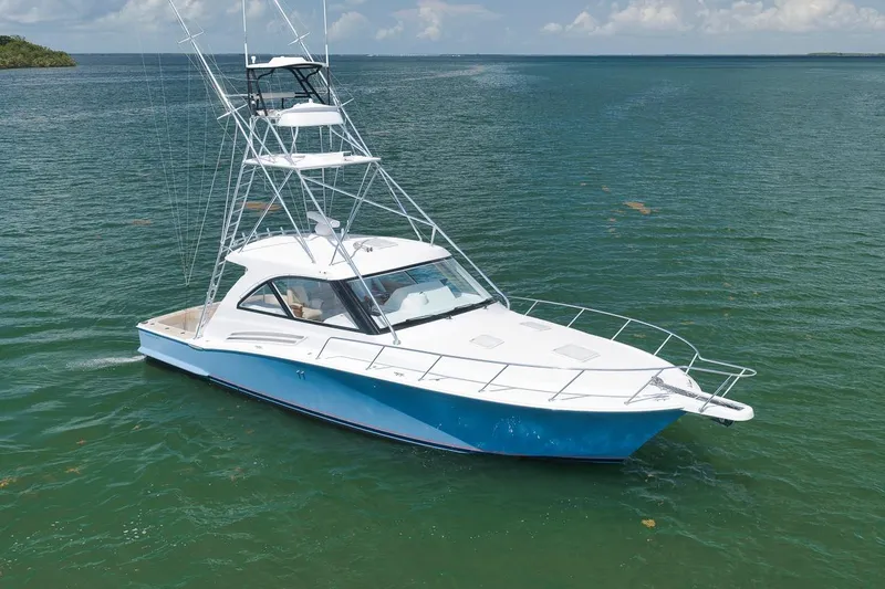 Slide: The Image of 2023 Hatteras GT45X Tower yacht on calm waters, showcasing sleek design and luxury features. - 2