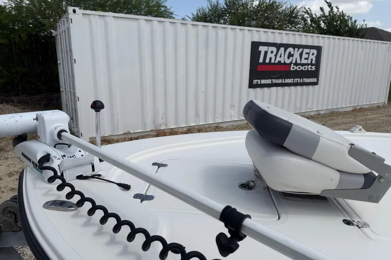 Slide: The Image of 2012 Mako 18 LTS boat with trolling motor, near Tracker Boats container. - 14
