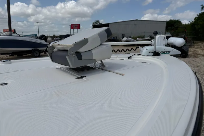 Slide: The Image of 2012 Mako 18 LTS boat deck with Minn Kota trolling motor under cloudy sky. - 11