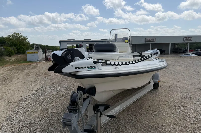 Slide: The Image of 2012 Mako 18 LTS boat with Minn Kota trolling motor on a trailer, outdoors. - 12