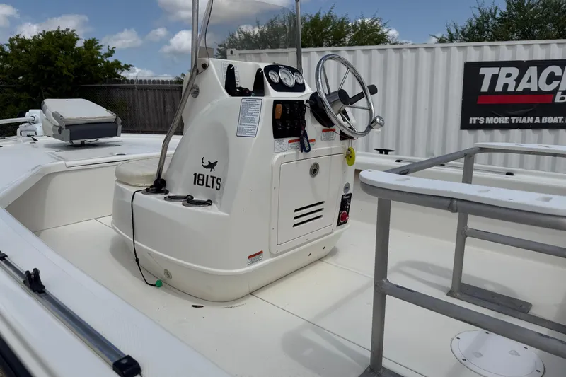 Slide: The Image of 2012 Mako 18 LTS boat interior with steering console and seating. - 16