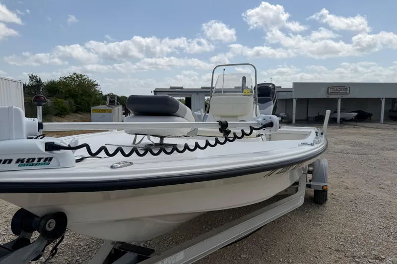 Slide: The Image of 2012 Mako 18 LTS boat on trailer, featuring Minn Kota trolling motor, under a partly cloudy sky. - 13