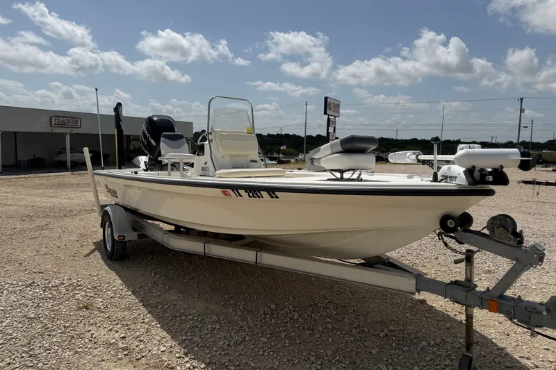 Slide: The Image of 2012 Mako 18 LTS boat on trailer under a partly cloudy sky. - 6