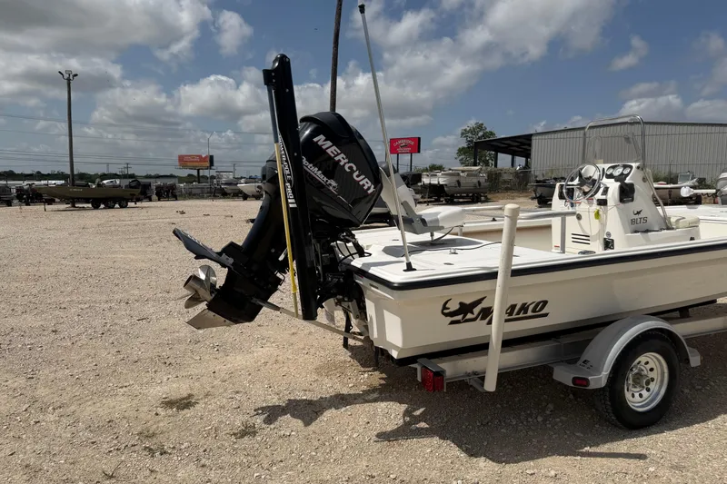 Slide: The Image of 2012 Mako 18 LTS boat with Mercury engine on a trailer, parked outdoors. - 4