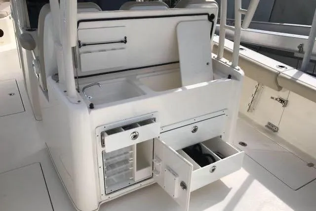 Slide: The Image of 2016 Cobia 344 Center Console boat interior with open storage compartments and seating. - 9