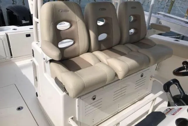 Slide: The Image of 2016 Cobia 344 Center Console boat with beige cushioned seating and storage. - 15