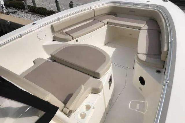 Slide: The Image of 2016 Cobia 344 Center Console boat interior with cushioned seating and spacious layout. - 10