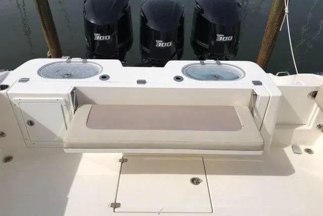 Slide: The Image of 2016 Cobia 344 Center Console boat with triple 300 horsepower engines and seating area. - 7