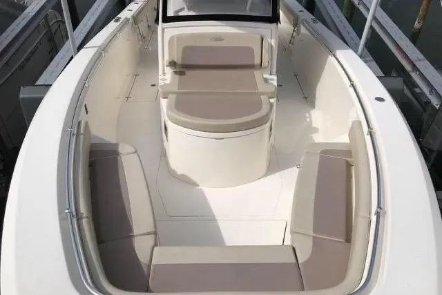 Slide: The Image of 2016 Cobia 344 Center Console boat interior with cushioned seating and sleek design. - 11