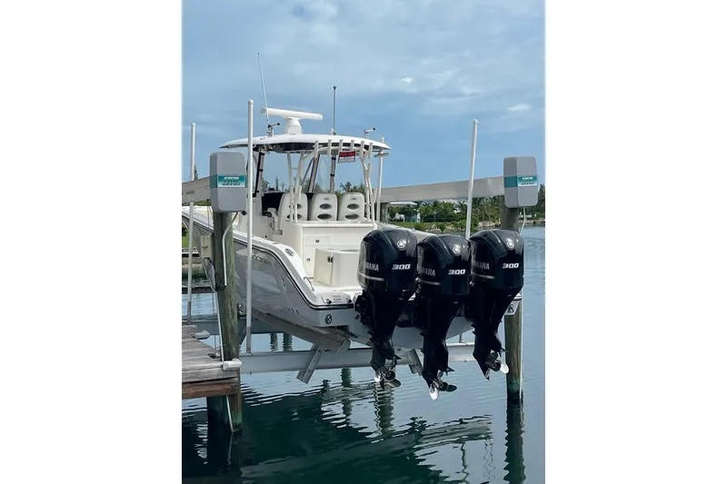 Slide: The Image of 2016 Cobia 344 Center Console boat with triple Yamaha 300 engines docked. - 22