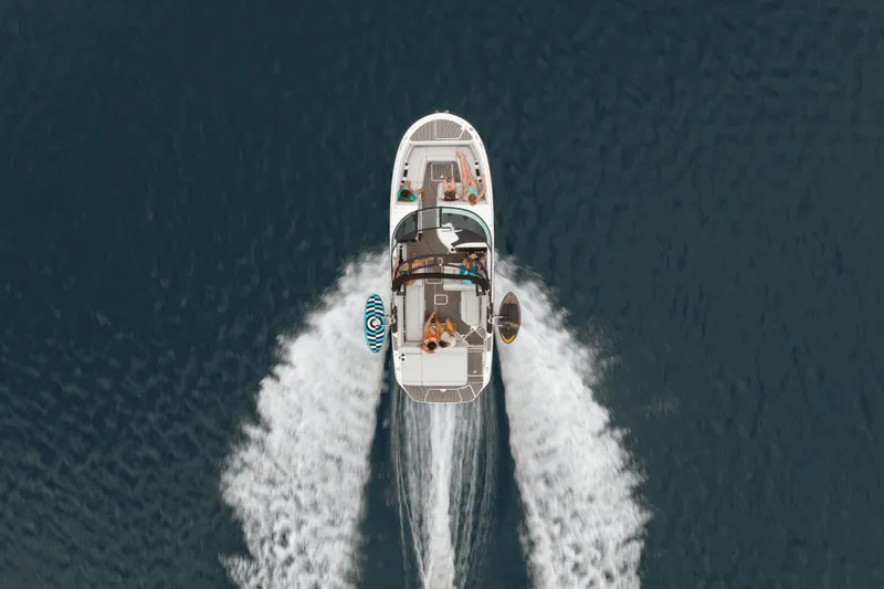 Slide: The Image of Aerial view of a Sea Ray SDX 270 Surf boat on the water with people on board. - 33