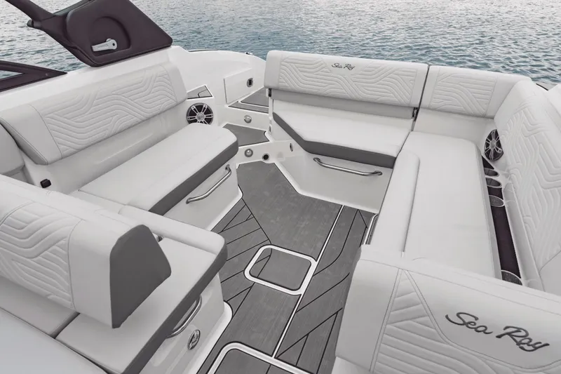 Slide: The Image of The image shows the luxurious cockpit of a Sea Ray SDX 270 Surf boat with white upholstery. - 18