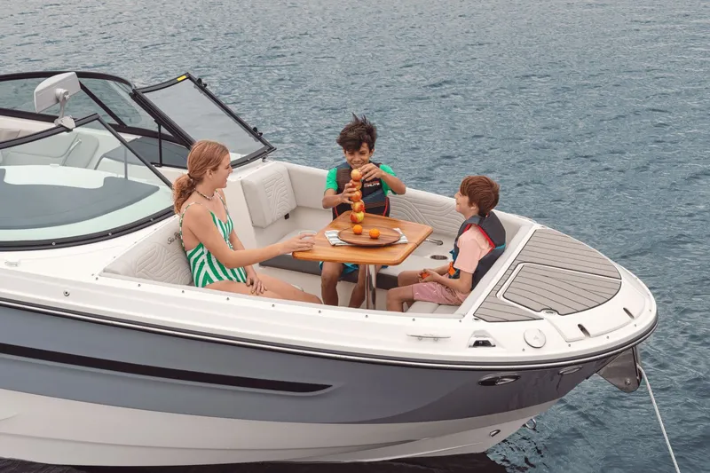 Slide: The Image of A family enjoys a picnic on a Sea Ray SDX 270 Surf boat on the water. - 7