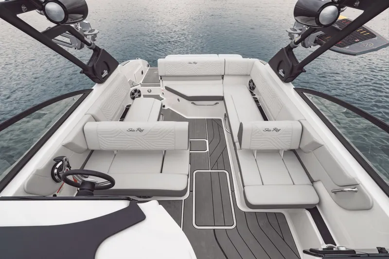 Slide: The Image of The image shows the spacious, luxurious cockpit of a Sea Ray SDX 270 Surf boat on calm water. - 17