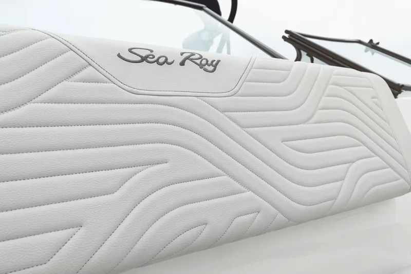 Slide: The Image of Close-up of a white textured upholstery with the Sea Ray logo. - 35
