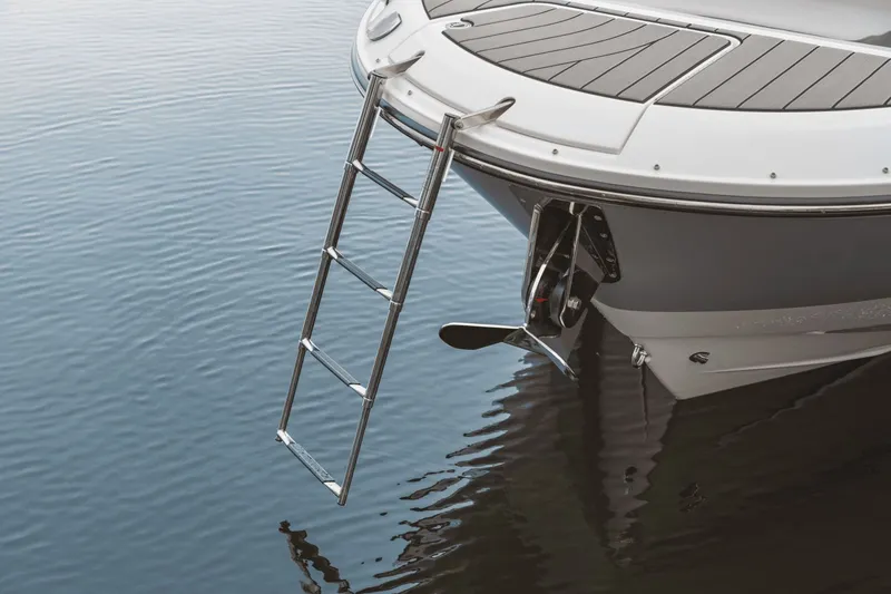 Slide: The Image of A 2025 Sea Ray SDX 270 Surf with a retractable swim ladder at the stern. - 16