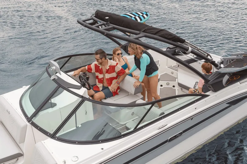 Slide: The Image of A family enjoys a ride on a Sea Ray SDX 270 Surf boat on the water. - 10