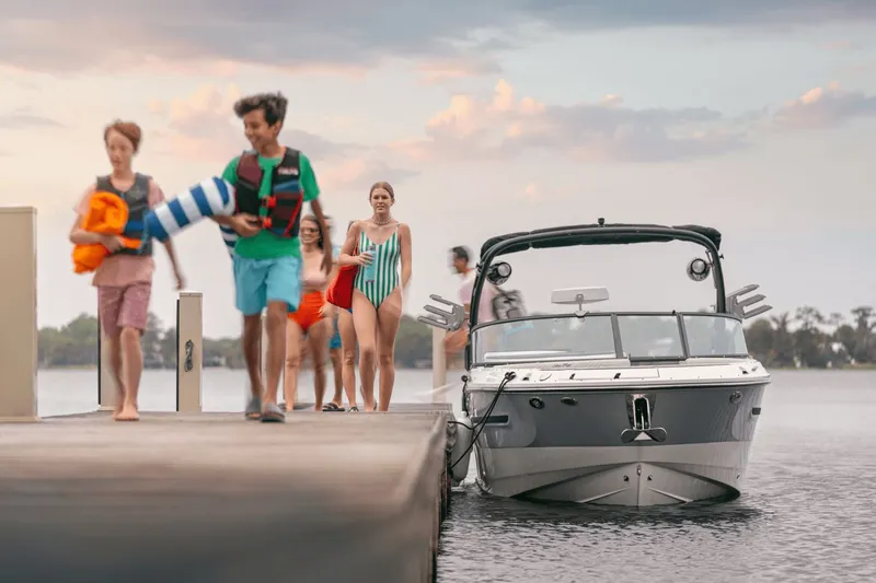 Slide: The Image of A group of people walks on a dock beside a Sea Ray SDX 270 Surf boat. - 19