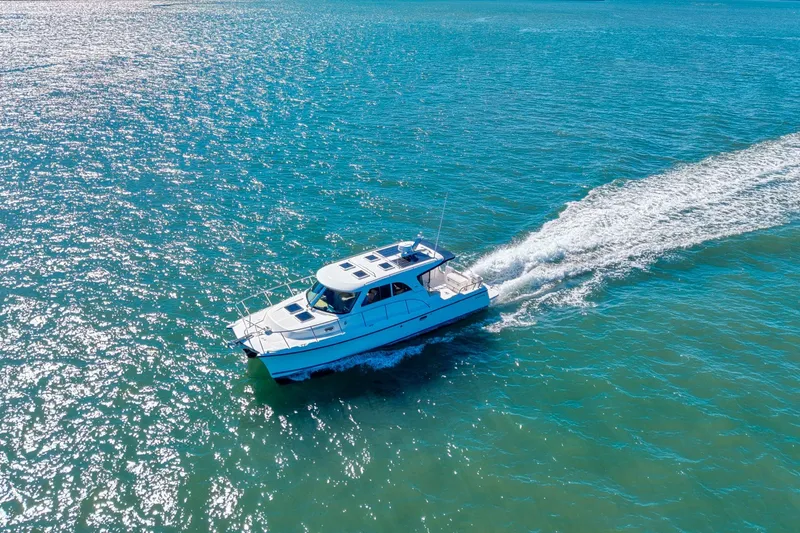 Slide: The Image of Aerial view of 2014 Aspen C100 boat cruising on sparkling blue water. - 5