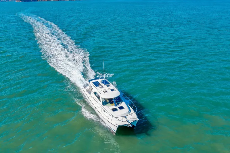 Slide: The Image of Aerial view of 2014 Aspen C100 boat cruising on clear blue water. - 7