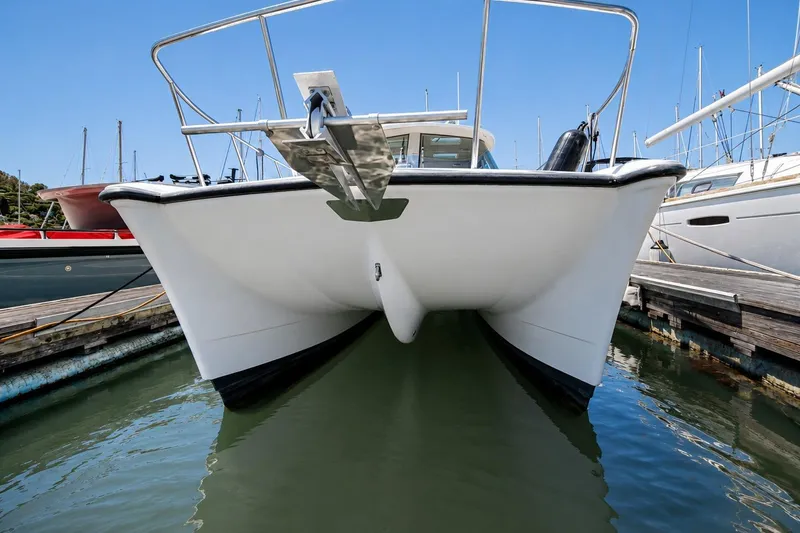Slide: The Image of Front view of a 2014 Aspen C100 boat docked in a marina. - 10