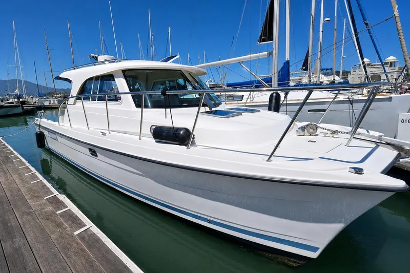 Slide: The Image of White Aspen C100 boat docked at marina, 2014 model, clear blue sky. - 2