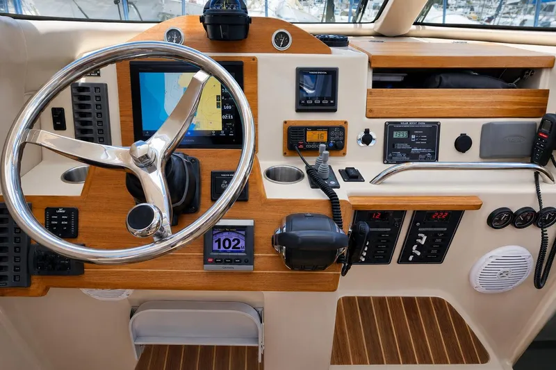 Slide: The Image of Cockpit of 2014 Aspen C100 boat with steering wheel and navigation instruments. - 7