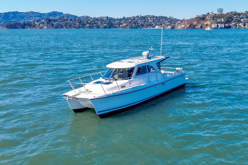 Slide: The Image of 2014 Aspen C100 boat cruising on a scenic blue lake with hills in the background. - 3