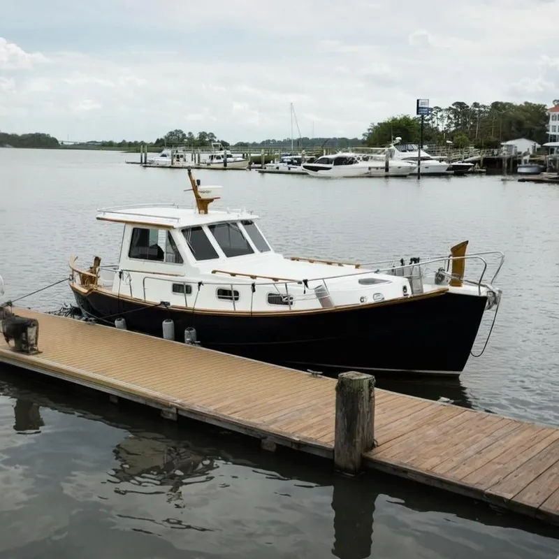 Slide: The Image of 2002 Menorquin 110 yacht docked at a marina, showcasing classic design and elegance. - 1