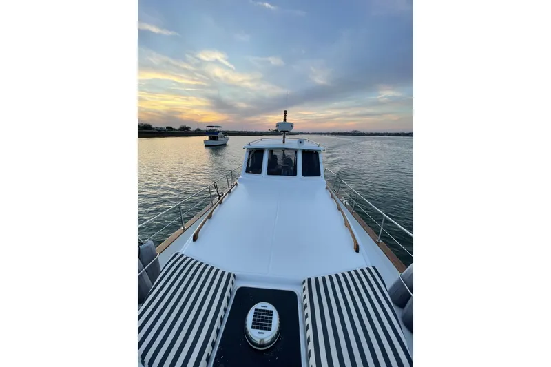 Slide: The Image of Menorquin 110 yacht from 2002 cruising at sunset on calm waters. - 10