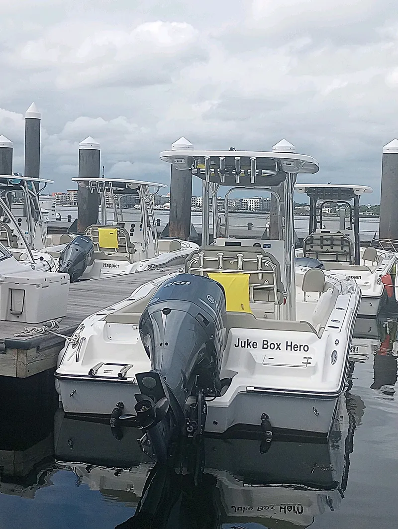 The Image of A 2024 Key West 239 FS boat docked. It features an outboard motor. - 0