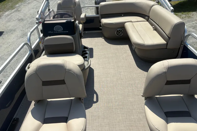 Slide: The Image of 2024 Sun Tracker Bass Buggy 16 DLX pontoon boat interior with beige seating. - 8