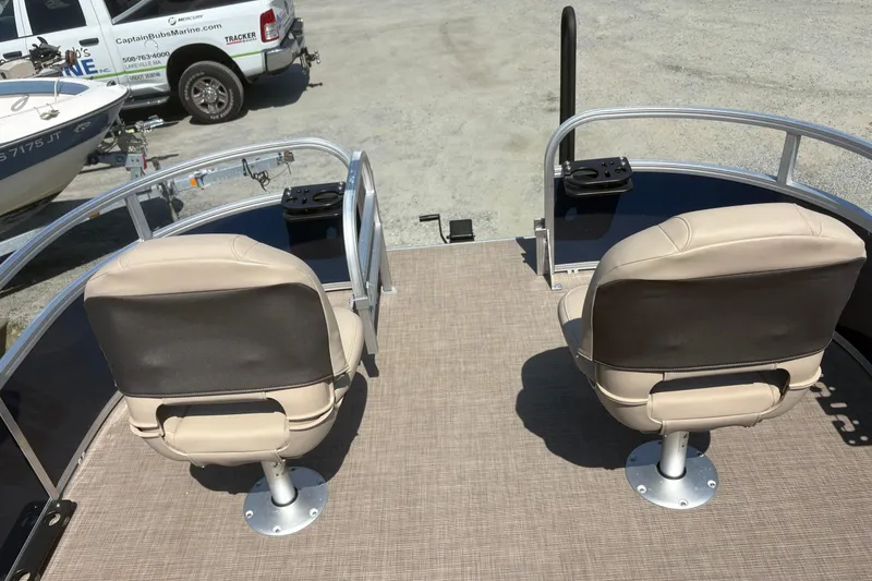 Slide: The Image of 2024 Sun Tracker Bass Buggy 16 DLX pontoon boat with beige seating and fishing rod holders. - 6