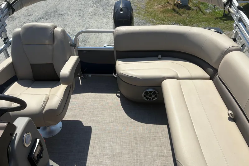 Slide: The Image of 2024 Sun Tracker Bass Buggy 16 DLX interior with beige seating and steering console. - 5