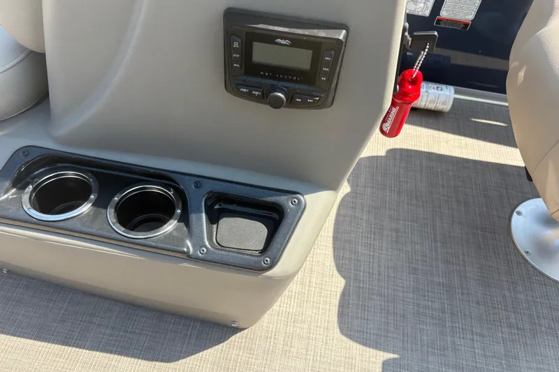 Slide: The Image of 2024 Sun Tracker Bass Buggy 16 DLX console with cup holders and control panel. - 9