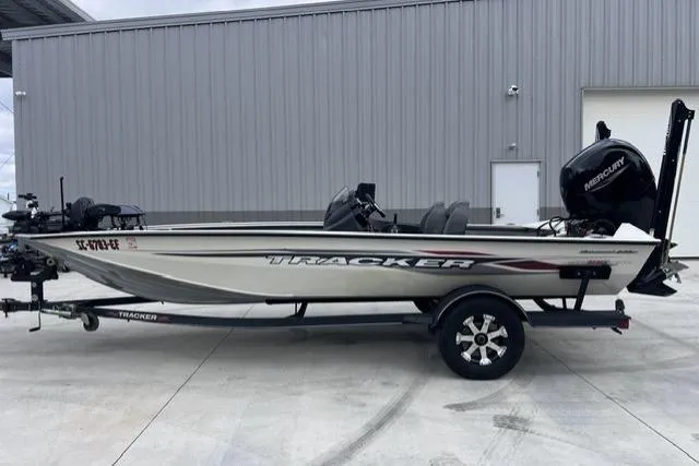 Slide: The Image of 2021 Tracker Pro Team 195 TXW Tournament Edition boat on trailer, parked outside a building. - 9