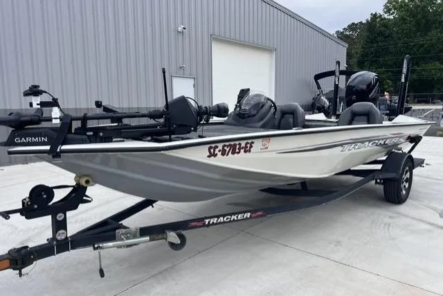 Slide: The Image of 2021 Tracker Pro Team 195 TXW Tournament Edition boat on trailer, parked outside a building. - 8