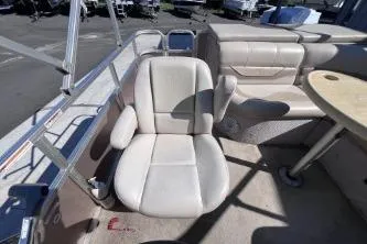 Slide: The Image of 2012 Avalon Tahoe boat interior with beige seating and table. - 12