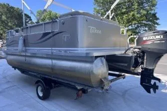 Slide: The Image of 2012 Avalon Tahoe pontoon boat with Suzuki outboard motor on trailer. - 7