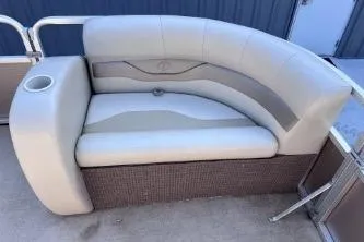 Slide: The Image of 2012 Avalon Tahoe boat seat with beige upholstery and integrated cup holder. - 10
