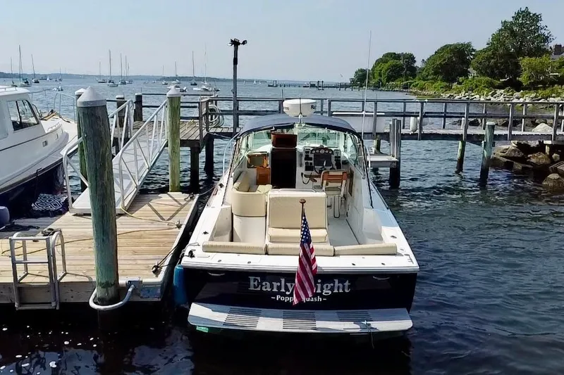 Slide: The Image of 2004 Hunt Yachts Surfhunter 29 docked at a marina with scenic waterfront views. - 3