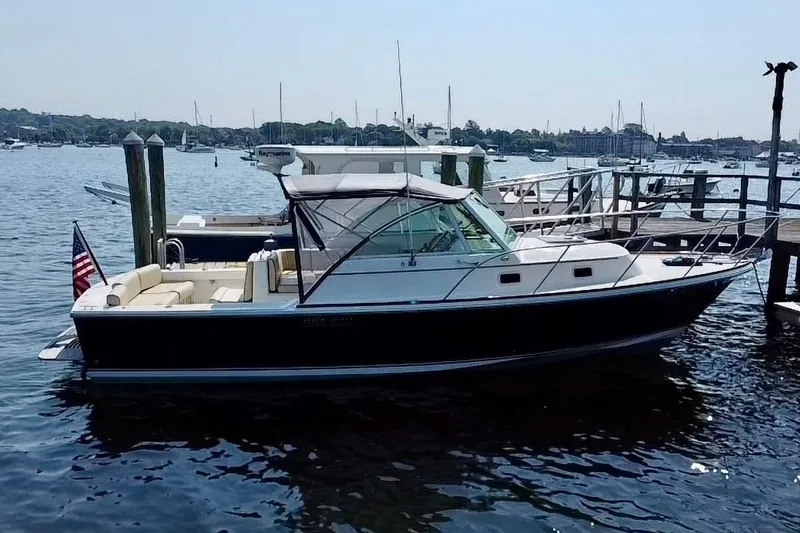 Slide: The Image of 2004 Hunt Yachts Surfhunter 29 docked in a scenic marina setting. - 32