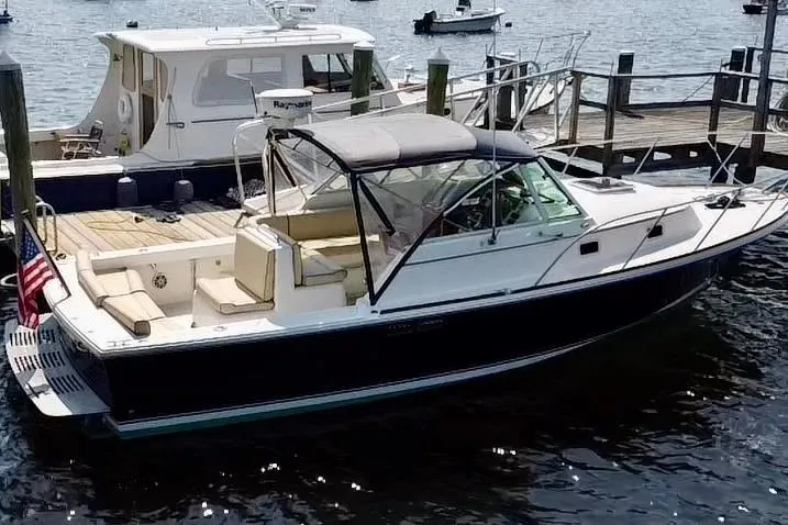 Slide: The Image of 2004 Hunt Yachts Surfhunter 29 docked, featuring sleek design and spacious deck. - 4