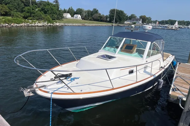Slide: The Image of 2004 Hunt Yachts Surfhunter 29 docked in a serene marina setting. - 1