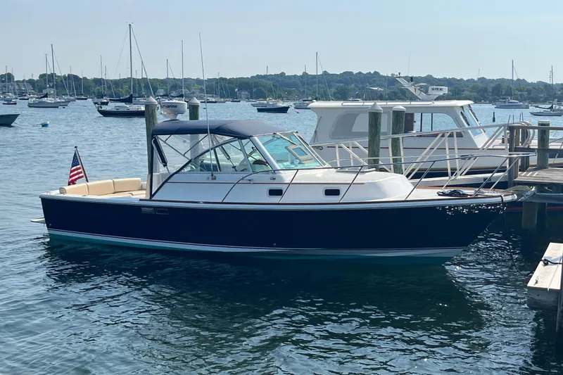 The Image of 2004 Hunt Yachts Surfhunter 29 docked in a marina with other boats. - 0