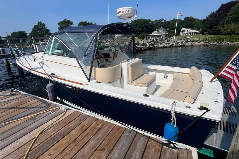 Slide: The Image of 2004 Hunt Yachts Surfhunter 29 docked, featuring a sleek design and comfortable seating. - 2
