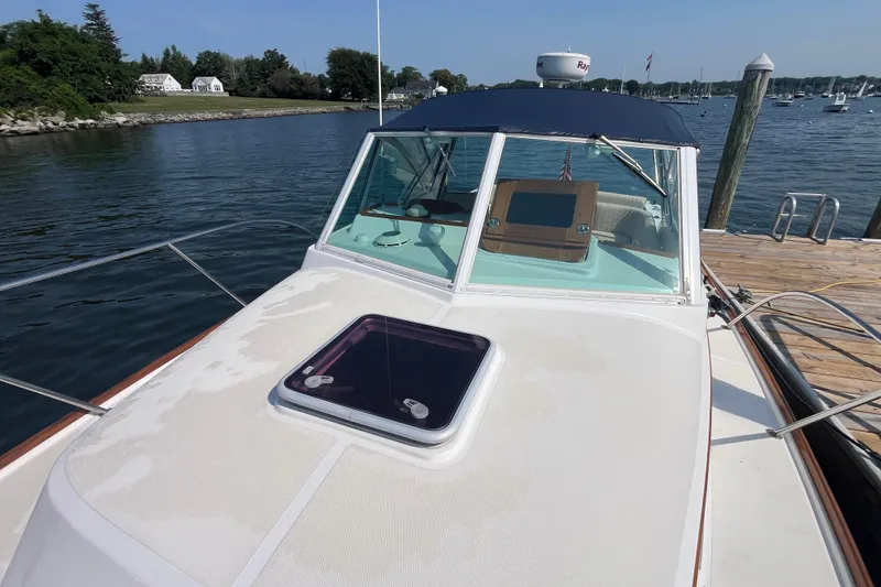Slide: The Image of 2004 Hunt Yachts Surfhunter 29 docked by a scenic waterfront. - 7