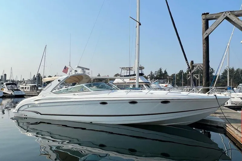 Slide: The Image of 2011 Formula 400 Super Sport boat docked in a marina, clear sky background. - 1